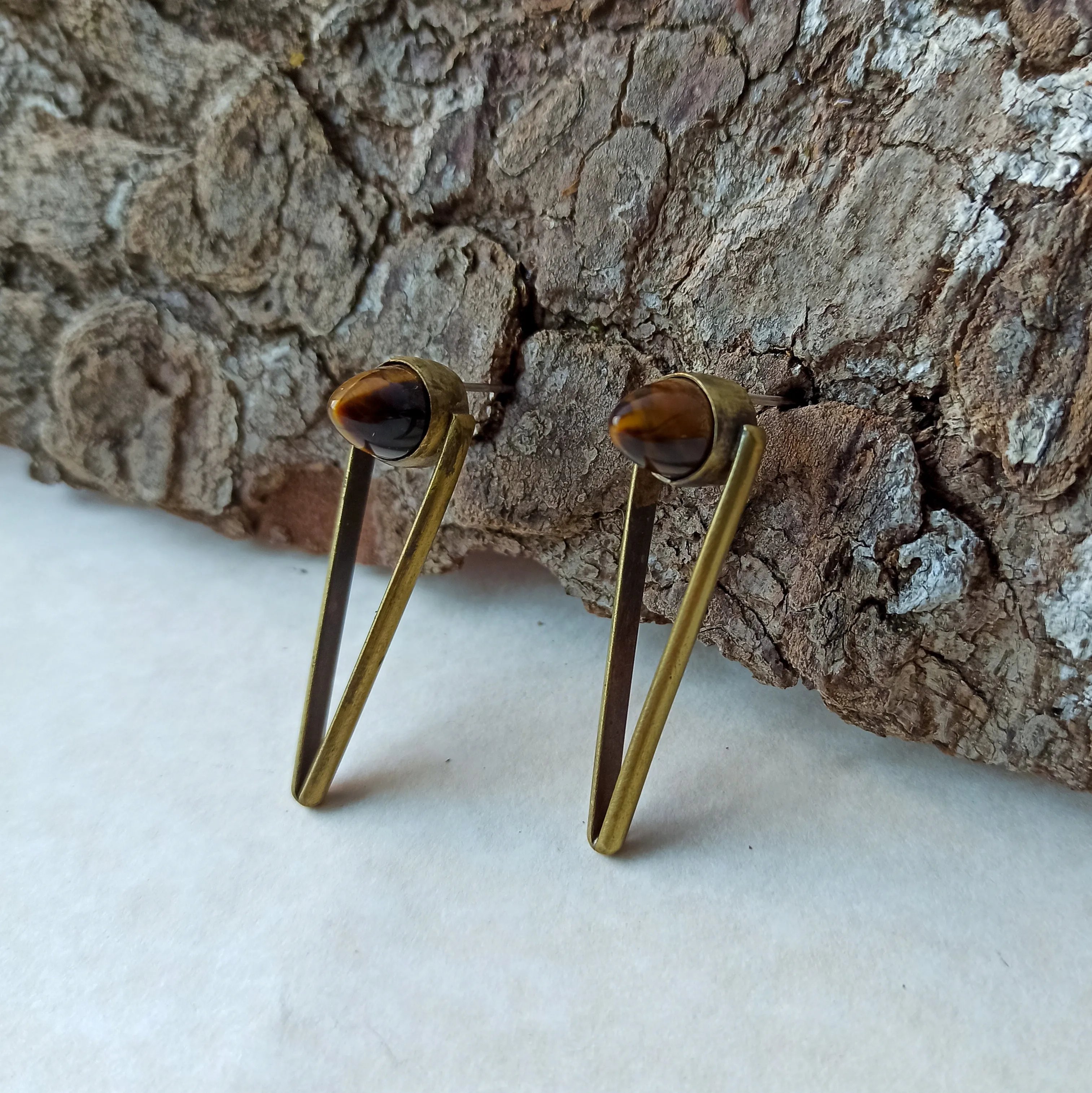 Bullet stud earrings with tiger eye cabochon.